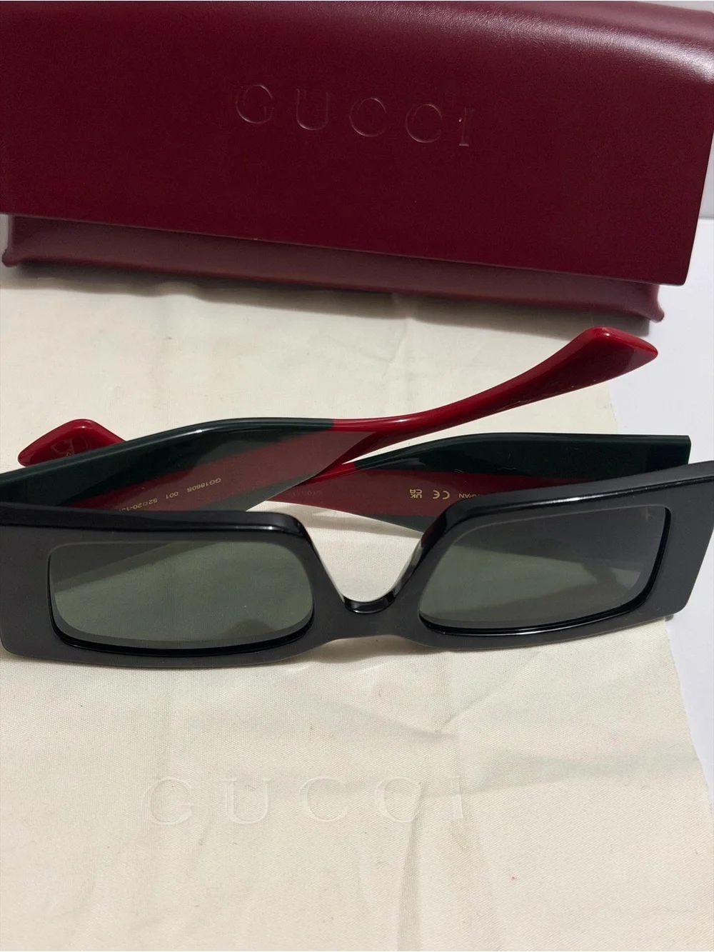 Gucci Black Frame Sunglasses with Red Temples and Gold Logo